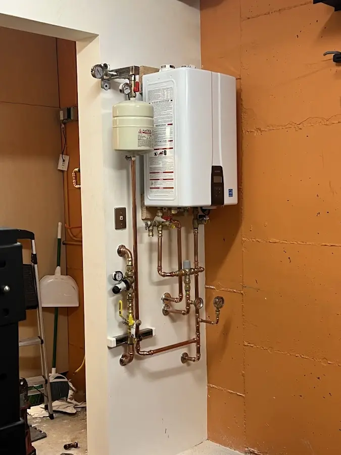 Plumbing technician inspecting water heater connections in Wailea